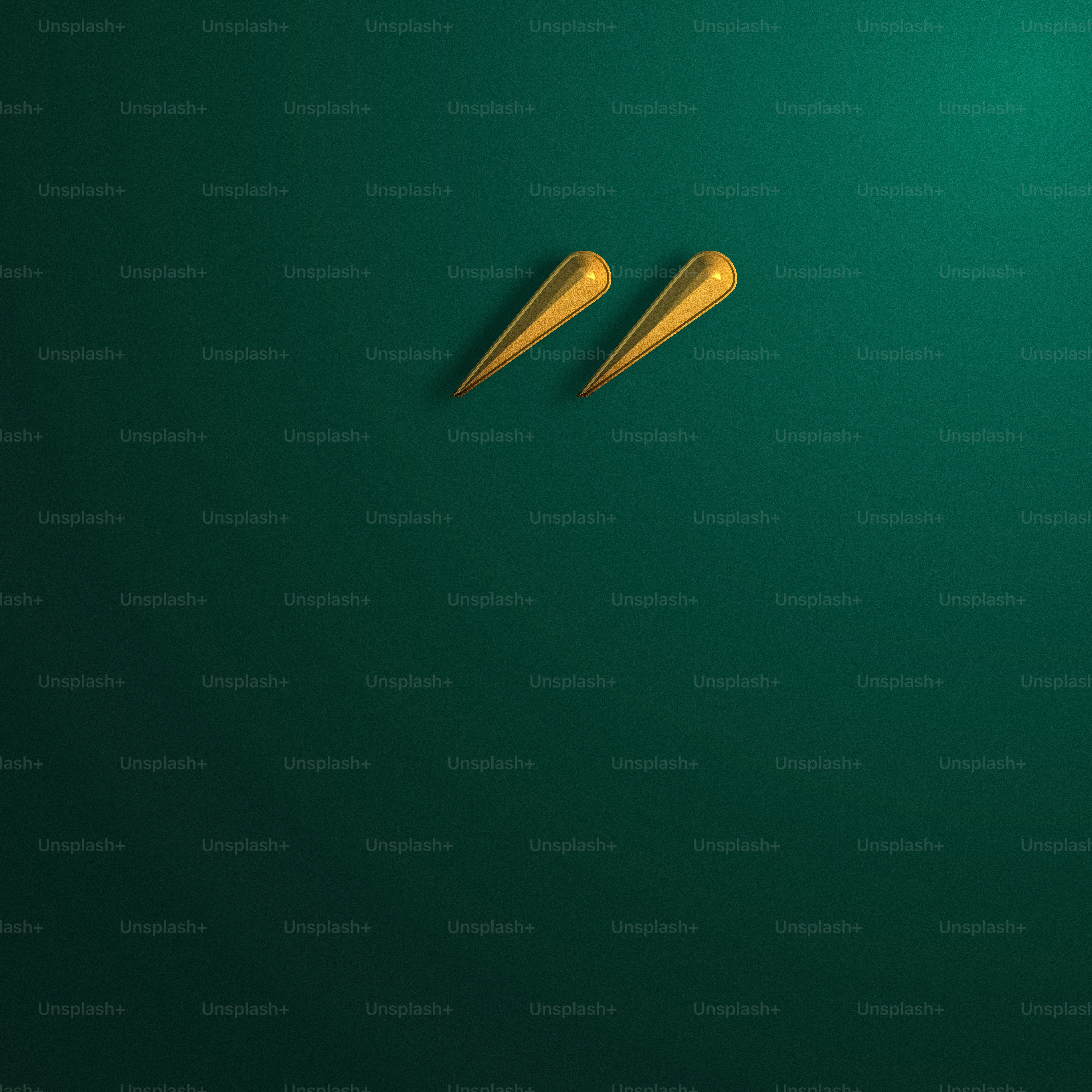 a pair of gold scissors on a green background